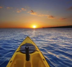 Kayak sailing in ocean sea at sunset or sunrise