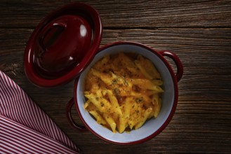 Macaroni and cheese italian pasta recipe on wood table