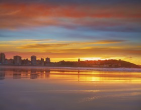 Gijon skyline sunset in San Lorenzo beach of Asturias in Spain