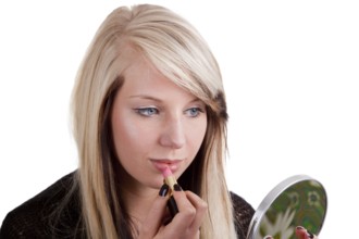 Young woman applying make-up - cropped on a white background