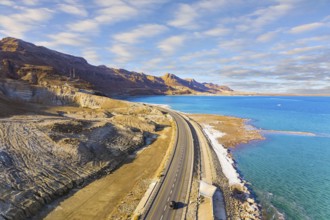 Sunset. Dead Sea photographed from a drone. Evaporated salt was deposited along the shore. Asphalt