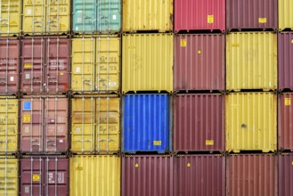 Standard shipping container in a container terminal in front of loading onto a container ship