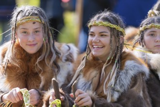 Two expression smiling girls in traditional clothing aboriginal of Kamchatka Peninsula. Itelmens