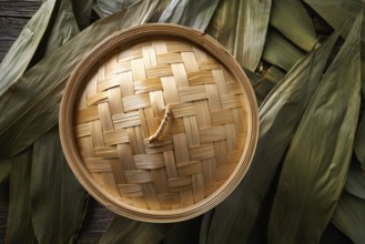 Asian kitchen bamboo steamer for steam cooking recipes on leafs