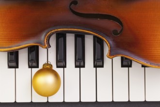 Top view close up shot of piano keyboard, old violin and Christmas decoration. Flat Lay Image