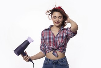 A trendy and fashionable young woman holding a hair dryer, fully embracing both style and beauty in