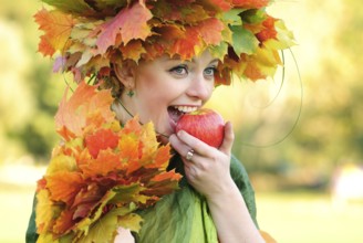 Woman with maple leaves outdoors. Close up face