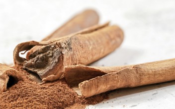Closeup detail - Heap of cinnamon bark sticks on white stone like desk, Liptovsky Hradok, Slovakia,