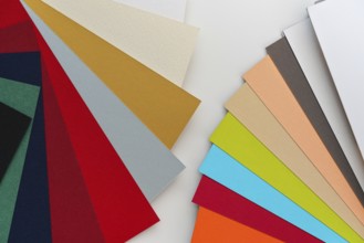 Bunte Papieruhren auf weißem Schreibtisch, Detail Nahaufnahme