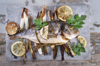 Presentation and preparation of a second dish of sea bream and onions