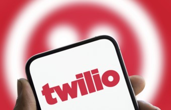 Twilio logo is displayed on smartphone. Twilio Inc is an American cloud communications company.