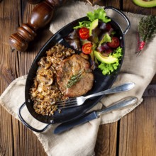 Pork steak with mushrooms and buckwheat groats and mango salad