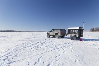 Winter, car with a heated trailer on the frozen Saint Lawrence River, Province of Quebec, Canada,