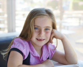 Blond relaxed happy kid girl expression blue eyes smiling