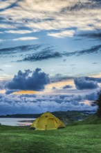 Evening at the Norwegian Seaside in summertime with atmospheric clouds. Evening at the Norwegian