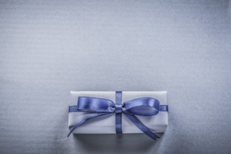 Wrapped gift box on blue background holidays concept