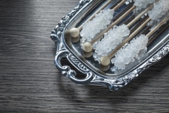 Tasty sugar sticks on metallic tray