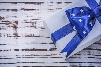 Wrapped present on vintage wooden board holidays concept