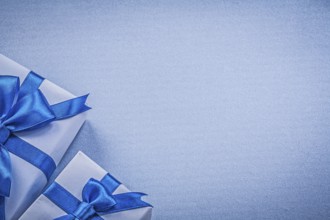 Packaged present boxes on blue background greeting card holidays concept