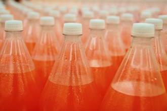 Orange juice beverage plastic bottle in factory line