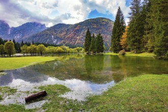 Midday in a mountain valley. Picturesque shallow lake Fuzine of glacial origin. The lake shores are