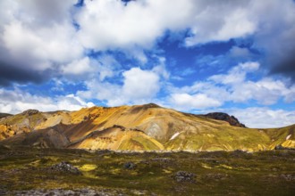 Multi-colored rhyolite mountains - orange, yellow, green and blue. Travel to Iceland in July,