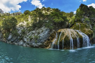 Scenic round waterfall in the side wall of the canyon Verdon. National park Merkantur, Provence,
