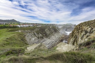 Cantabria Beaches, Portio Beach. Windy stormy day on the Atlantic coast. Giant rough gray rocks and