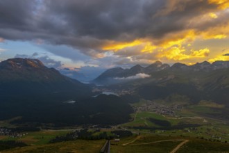 Beautiful Aerial View over Five Lakes and Swiss Alps and Cityscape in Sunset and Storm Clouds over