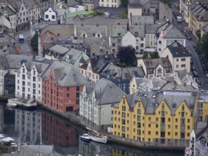 Colourful buildings on the harbour are reflected in the water. Historic architecture and