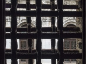 View trough iron grills of Circolo Artistico, the former prisons' building of the Doge's Palace,