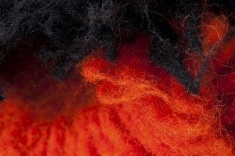 Black and red wool fibers closeup