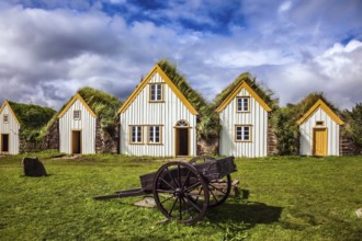 Facade of the farmhouse and ancient rural wheelbarrow. The concept of the historical and cultural