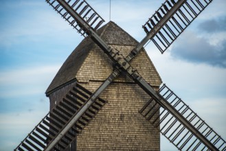 Large brown windmill in front of a blue sky in Berlin, Marzahn
