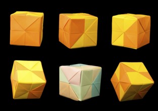 Paper made multi colored patterned cubes folded origami style. Yellow and orange colors