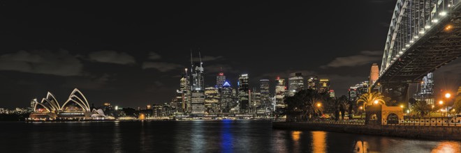 Sydney Opera House at night from Milsons Point and with skyline in the background. Reupload after
