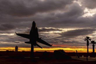 Dawn at Naval Air Field El Centro, CA: Sunlight paints vibrant hues across the sky, casting a