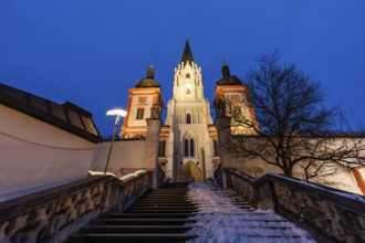 Snow on staircase, facade of the pilgrimage church, basilica of Mariazell, blue hour in the early
