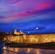 Salamanca skyline sunset and roman bridge over Tormes river in Spain
