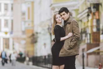 Urban modern young love couple walking romantic talking talking, holding hands on a date. Young