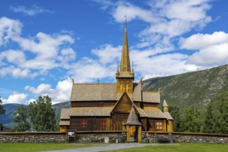The famouse historic wooden church in Lom in Norway with blue sky summertime