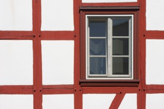Close-up of the beam construction of a half-timbered house with windows