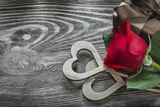Wooden hearts red rose gift box on wood board holidays concept
