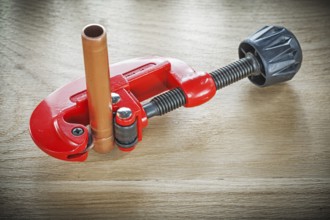 Flared pipes pipe cutter on wooden board top view