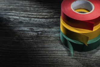 Rolled insulation tapes on wooden board