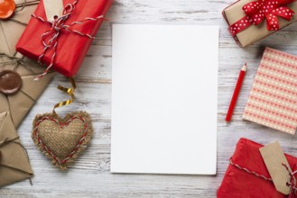 White paper and retro mail envelopes on wooden table. Flat lay cute composition with handmade