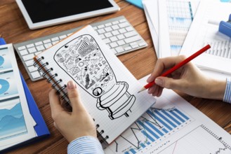 Close-up, woman draws business notes in her notebook. Business Innovation Concept