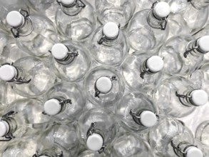 Transparent bottles seen from above. They can be filled with water, wine or other beverage. They