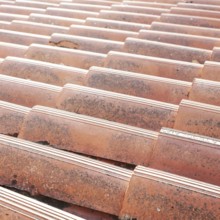 Old tiled roof. Close up of the red clay roof tiles. Background of old roof