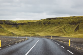 Road and mountain view during road trip in iceland. Foggy landscape in autumn time.
